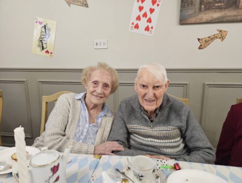 Residents, staff and family members enjoying the Mad Hatter’s Tea Party at Nightingale House