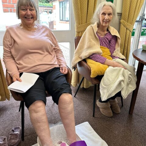 Two residents enjoying a relaxing foot spa activity together