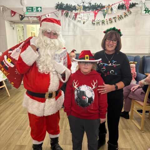 Residents and guests sharing smiles at the Christmas party at Nightingale House