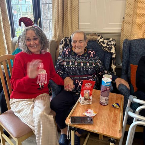Residents and visitors socialising during the Christmas party at Nightingale House