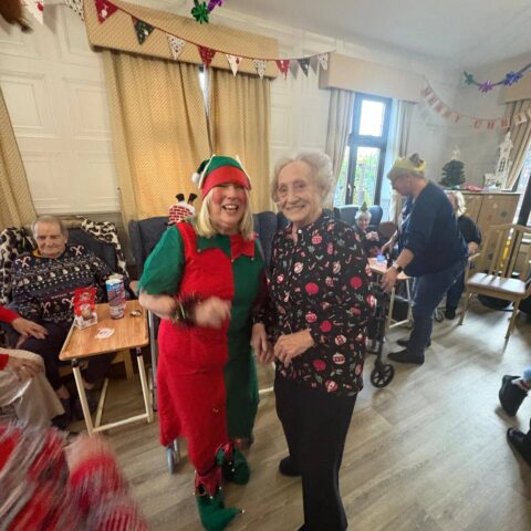 Residents enjoying a festive Christmas social event at Nightingale House