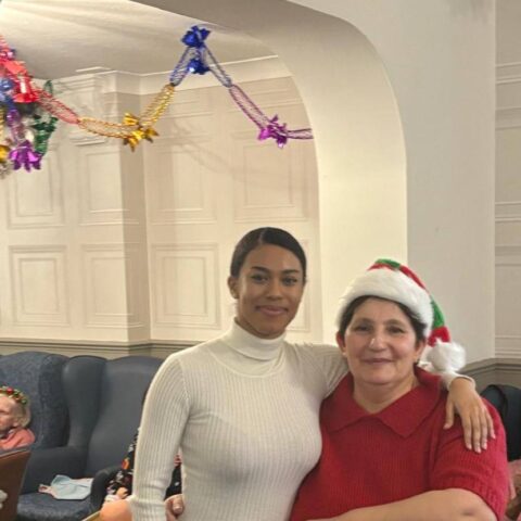 Festive Christmas party scene at Nightingale House with residents and visitors celebrating together