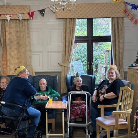 Residents and visitors gathered around tables beneath festive decorations