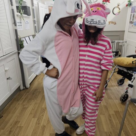 Residents, staff and family members enjoying the Mad Hatter’s Tea Party at Nightingale House