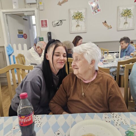 Residents, staff and family members enjoying the Mad Hatter’s Tea Party at Nightingale House