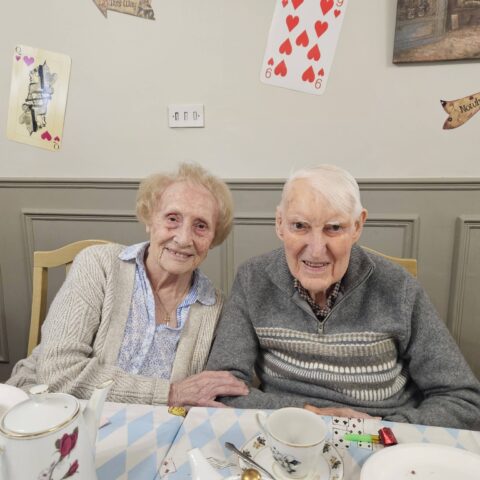 Residents, staff and family members enjoying the Mad Hatter’s Tea Party at Nightingale House