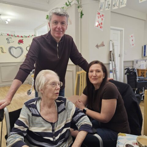 Residents, staff and family members enjoying the Mad Hatter’s Tea Party at Nightingale House