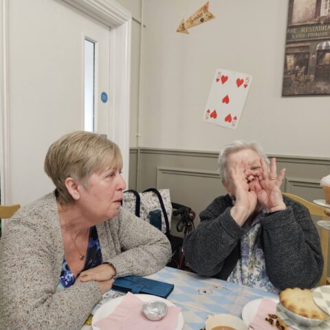 Residents, staff and family members enjoying the Mad Hatter’s Tea Party at Nightingale House
