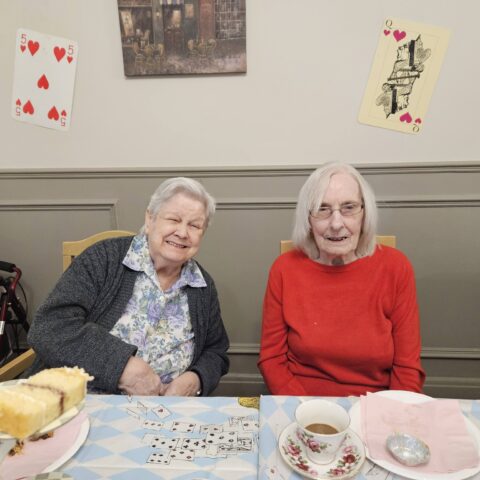 Residents, staff and family members enjoying the Mad Hatter’s Tea Party at Nightingale House