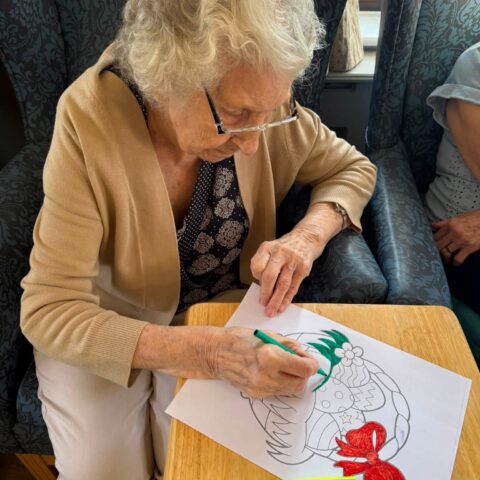 Resident colouring a picture during an arts and crafts activity